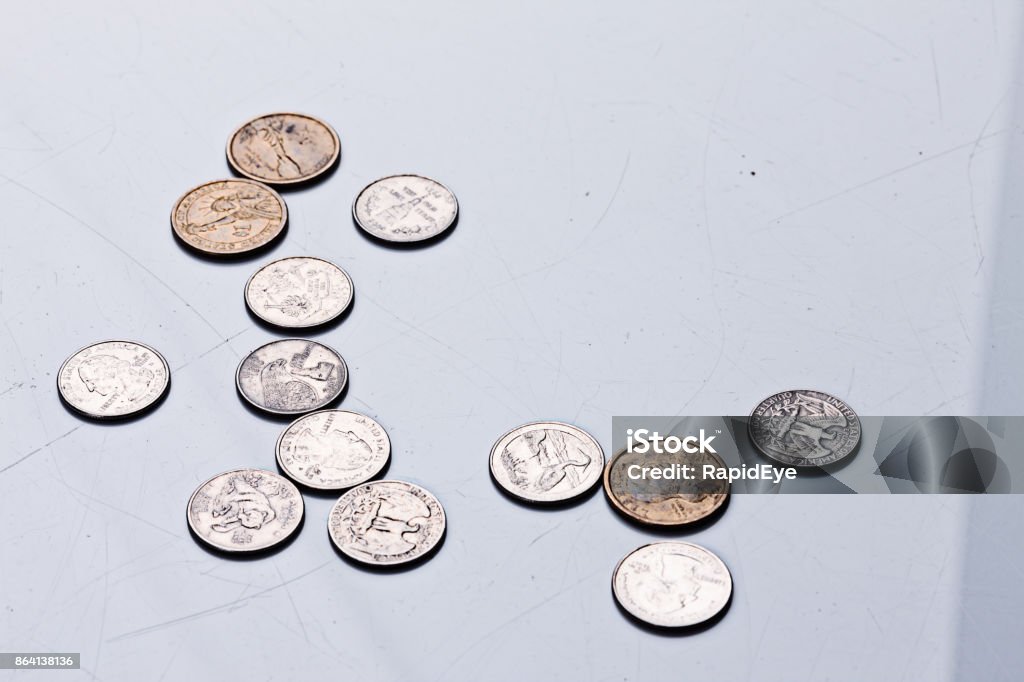 American coins scattered on a gray background A large number of various used American coins is scattered on a grey background with copy space. Allowance Stock Photo