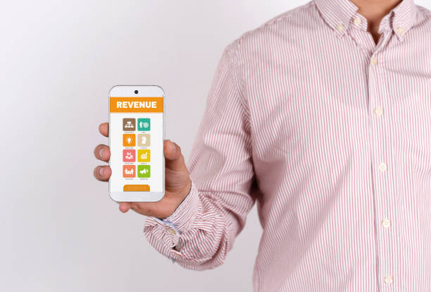 istock Man showing smartphone Revenue on screen 864146036