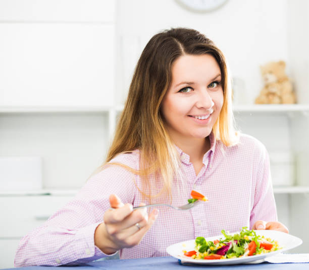 istock Woman tasting fresh green salad 864146044