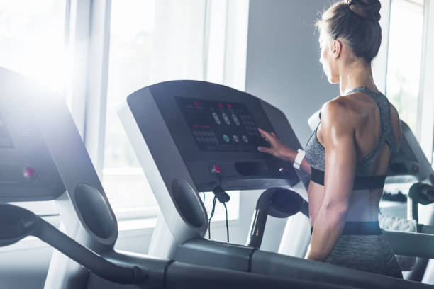 istock woman exercising on treadmill 864146446