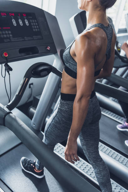 istock woman exercising on treadmill 864149520