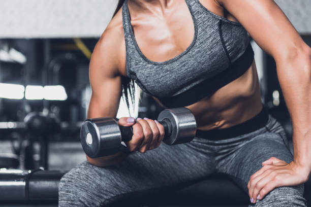 istock sportive woman exercising with dumbbell 864157962