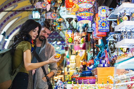 Young tourist couple shopping in in Grand Bazaar, Istanbul, Turkey