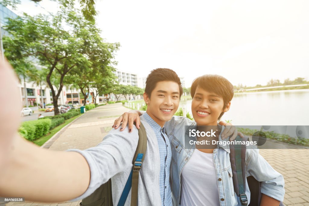 Taking photo together Hugging happy friends taking selfie outdoors Adult Stock Photo