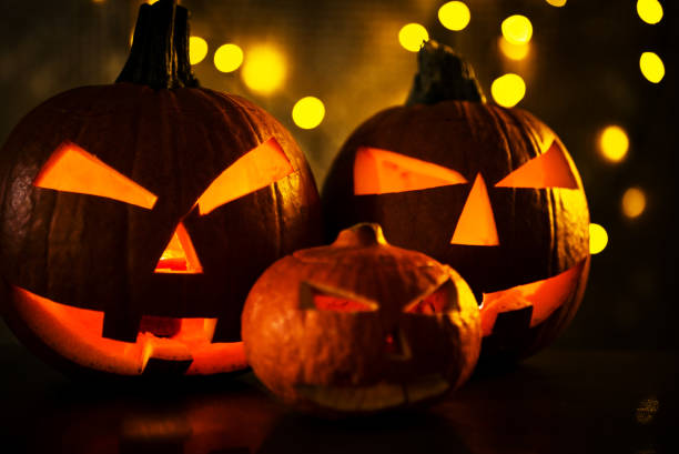 istock Halloween design with pumpkins. golden bokeh 864169452