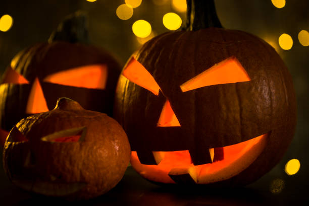 istock Halloween design with pumpkins. golden bokeh 864169508