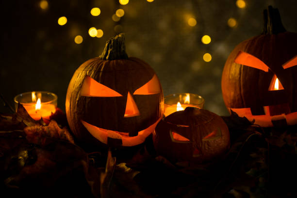 istock Halloween design with pumpkins. golden bokeh 864169666