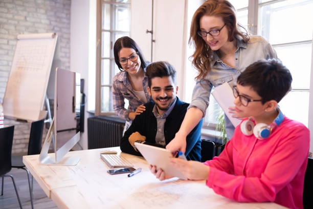 istock Coworkers working on project together in office 864170286