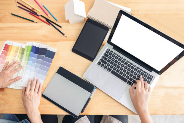 istock Young colleagues designers working together on a creative project and color samples for selection, Color swatch samples, Brainstorming Planning Partnership, creative graphic design working desktop 864177424