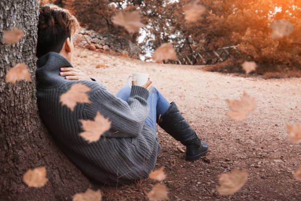 istock Enjoying the autumn forest with a mug 864179908