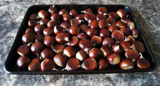 istock Sweet chestnuts on a baking tray 864192342