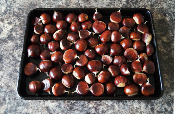 istock Sweet chestnuts on a baking tray 864192346
