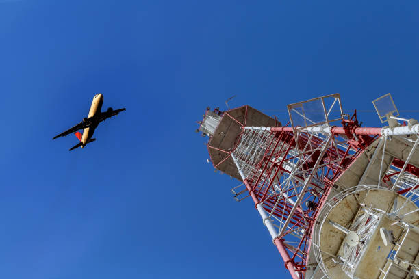 istock Telecommunications tower against blue sky, in red and white 864209108