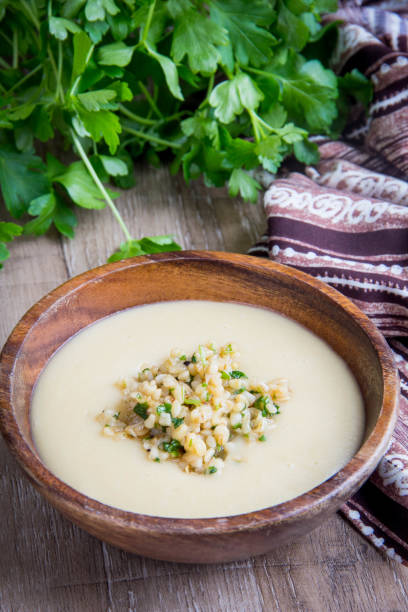 istock White cream soup with vegetables, mushrooms, rice, bulgur, tasty light first course 864209476