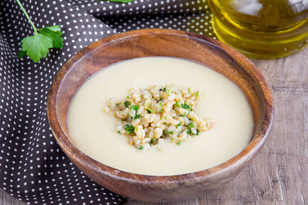 istock White cream soup with vegetables, mushrooms, rice, bulgur, tasty light first course 864209904