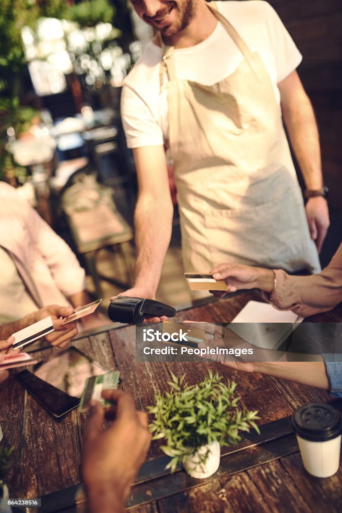 Let's all pay Shot of unrecognizsble people wanting to pay with a credit card outside Credit Card Stock Photo