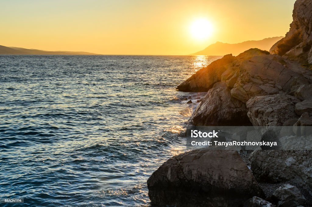 Sunset at the sea. Beautiful sunset on the sea in the summer evening. Arrival Stock Photo