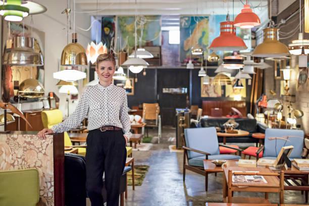 portrait of a female business owner standing in her furniture store - light shop imagens e fotografias de stock