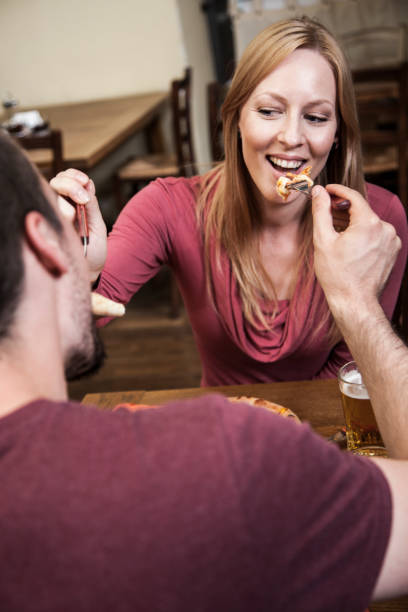 istock Young couple in love feeding each other 864255076