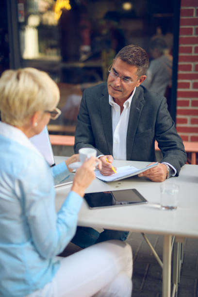 istock Mature business people collaborating after work 864259244