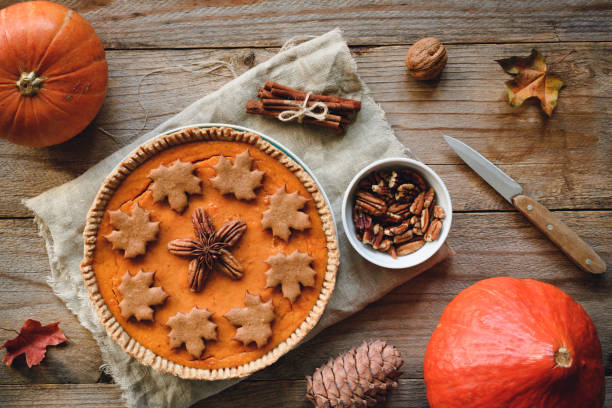 istock Pumpkin pie with pecan nuts on wooden background 864259454