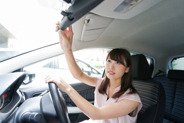 istock Woman in car checking mirror 864259606