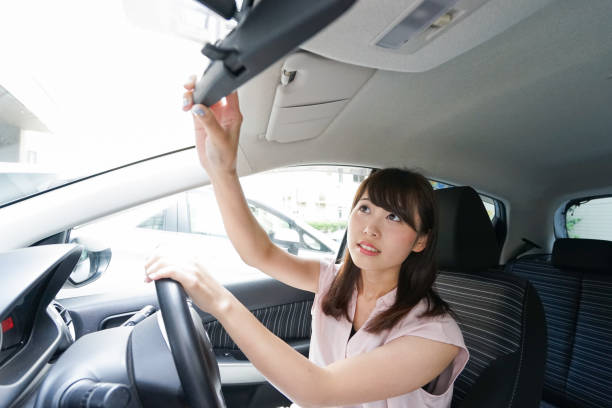 istock Woman in car checking mirror 864259608