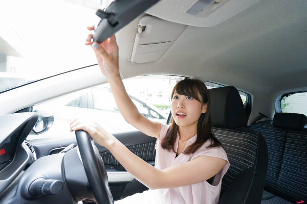 istock Woman in car checking mirror 864259614