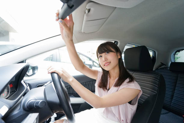 istock Woman in car checking mirror 864259620