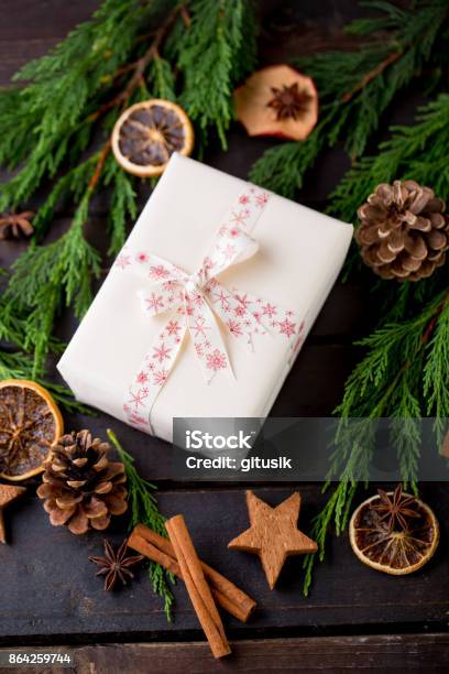 Christmas Gift On The Antique Wooden Background Stock Photo - Download Image Now - Arm, Christmas, Christmas Tree