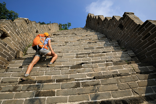 woman tourist climbing to the top of greatwall enjoy the view
