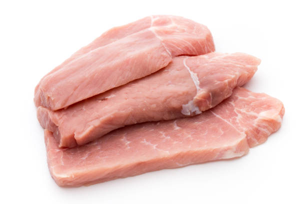 istock Fresh pork fillet with basil on a white background. 864263884