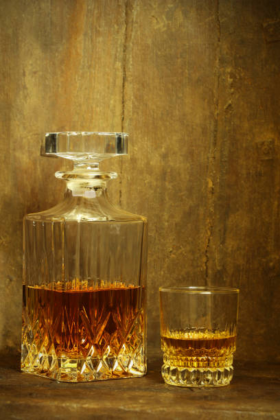istock Crystal Whisky Decanter and a Glass Against Rustic Background 864273332