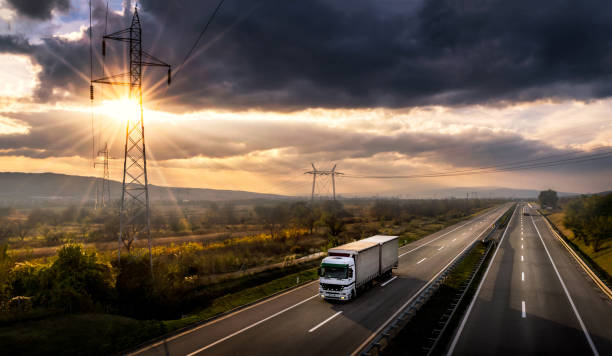 istock White lorry on a highway at sunset 864278300