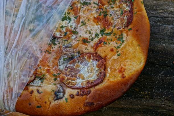 istock part of pizza with salami in cellophane package 864278600