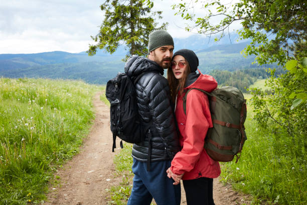 istock Young couple walking together in mountains 864286806