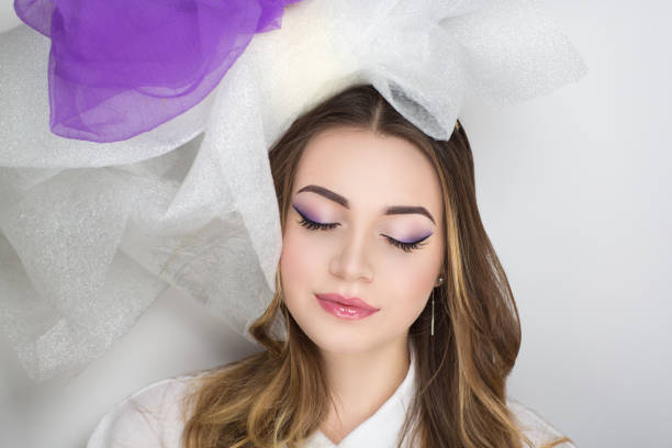 Young woman face with gorgeus makeup and trendy nails in closeup. Fachion and beauty concept