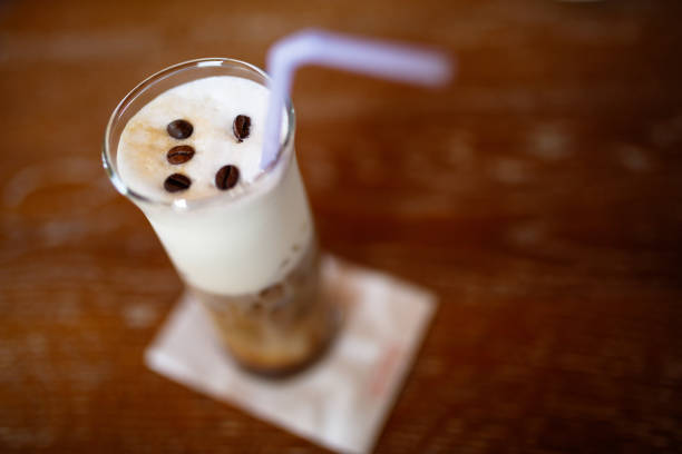 Iced coffee with cream and coffee beans