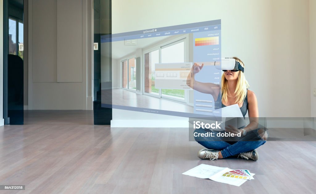 Woman decorating with virtual reality glasses Young woman using decoration application with virtual reality glasses Virtual Reality Stock Photo