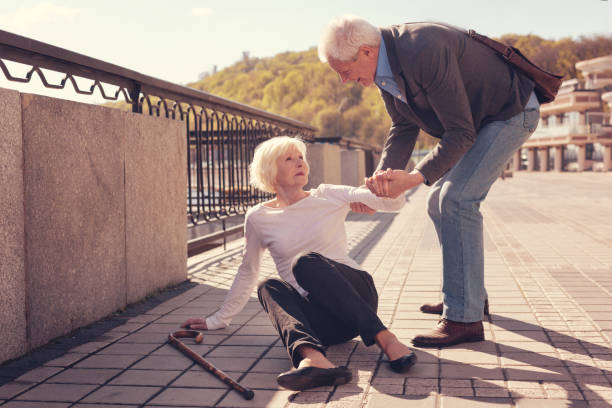 istock Polite elderly man helping a woman to get up 864312380