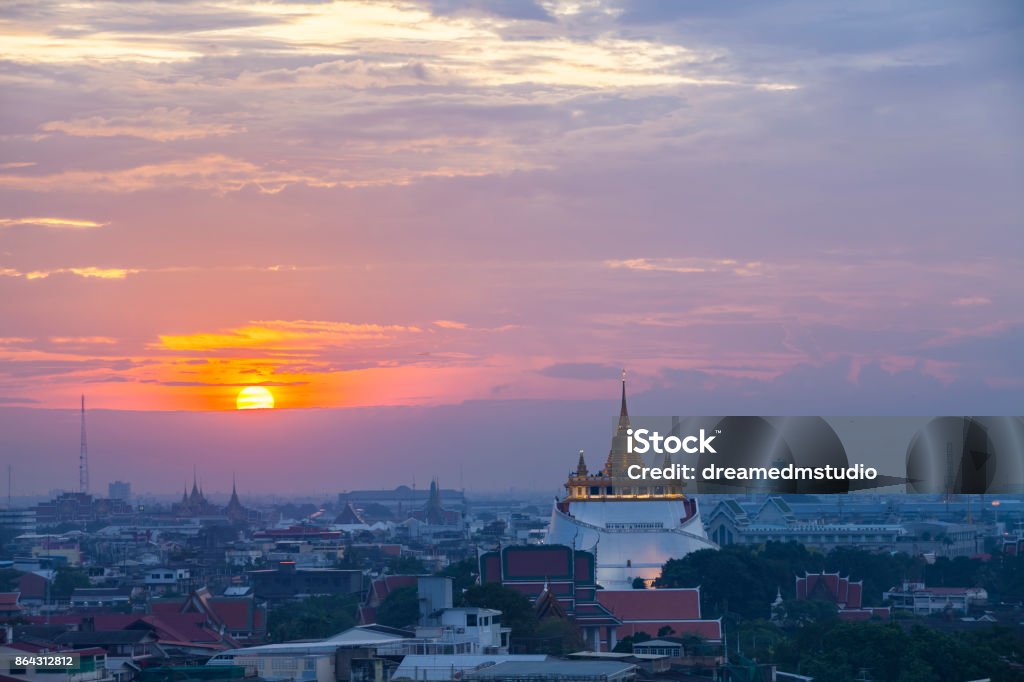 Golden Mount Temple with sunset in Bangkok at dusk (Wat Saket, Thailand) Rama I's grandson, King Rama III (1787–1851), decided to build a chedi of huge dimensions inside Wat Saket, but the chedi collapsed during construction because the soft soil of Bangkok could not support the weight. Over the next few decades, the abandoned mud-and-brick structure acquired the shape of a natural hill and was overgrown with weeds. The locals called it the "phu khao", as if it were a natural feature. Architecture Stock Photo