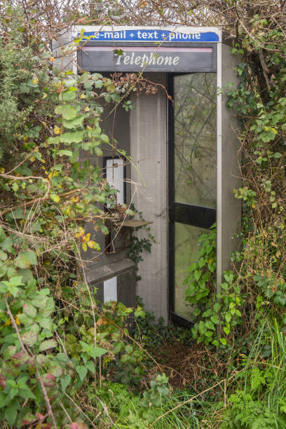 istock Derelict abandoned telephone, email, text box brambles overgrowing the kiosk 864316316