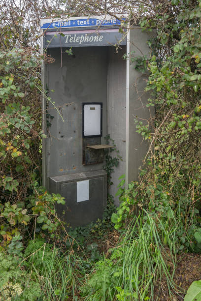 istock Derelict abandoned telephone, email, text box brambles overgrowing the kiosk 864316492
