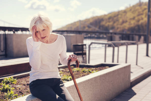istock Elderly woman suffering from a splitting headache 864316766