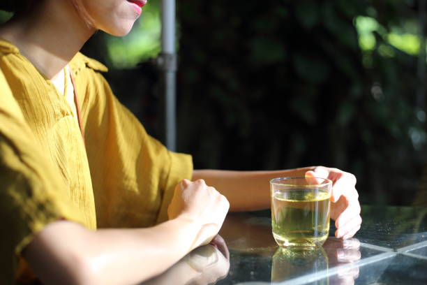 istock Young woman drinking green tea 864316796