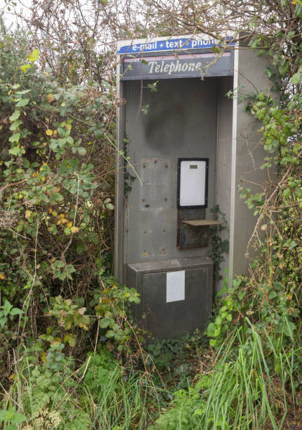 istock Derelict abandoned telephone, email, text box brambles overgrowing the kiosk 864316846