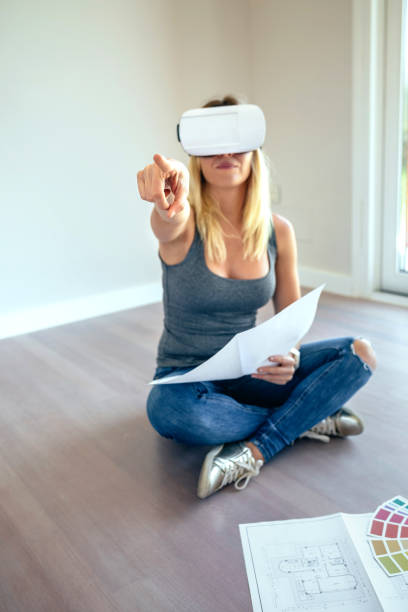 istock Woman watching with virtual reality glasses 864319700