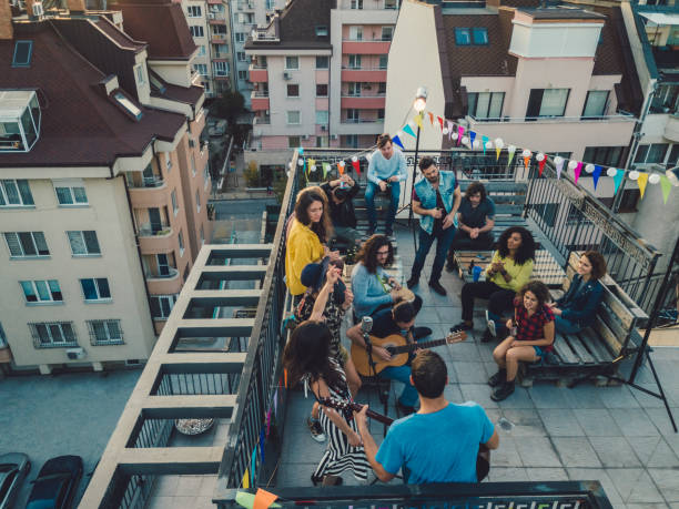 istock Friends enjoying a rooftop concert 864321338