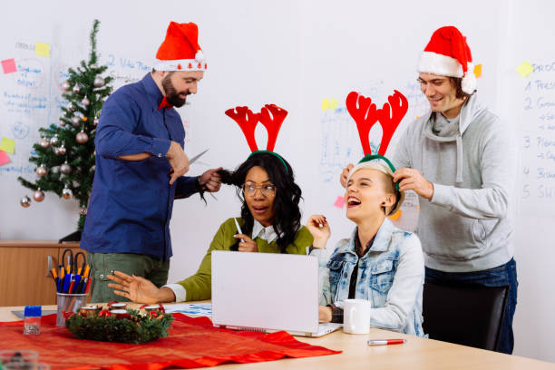istock Colleagues celebrating Christmas in office during working hours 864325062