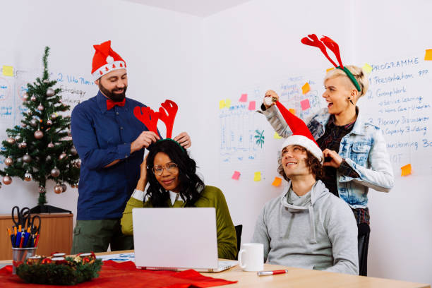istock Colleagues celebrating Christmas in office during working hours 864325086